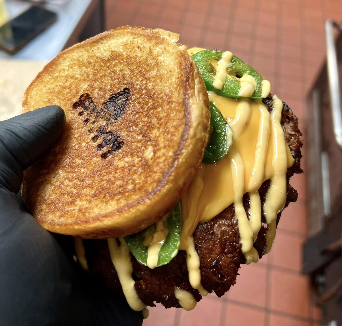 The City Boy Jalapeno Boy burger with a branded bun, fresh jalapenos and melted cheese