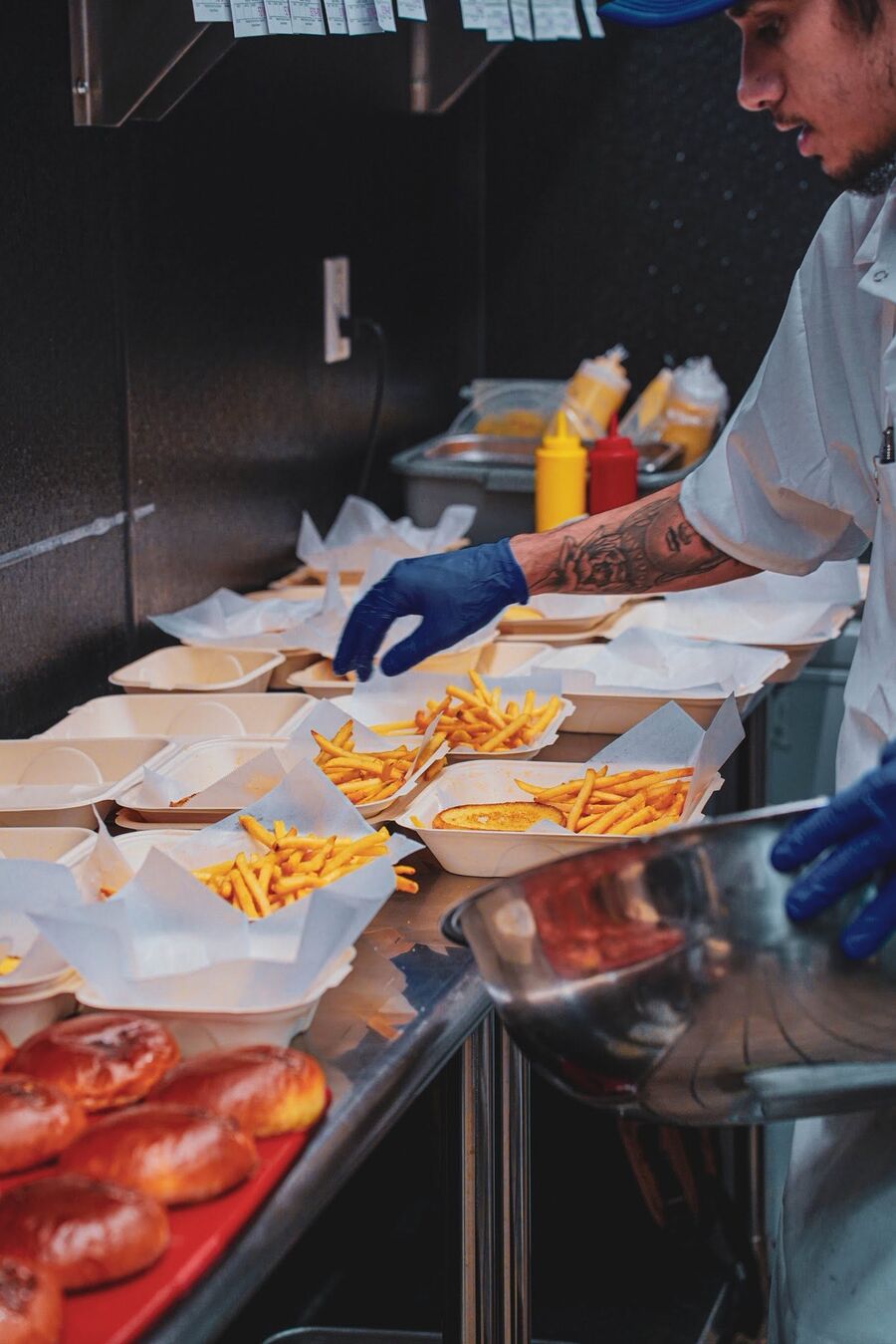 Prepping fries and toppings on the line
